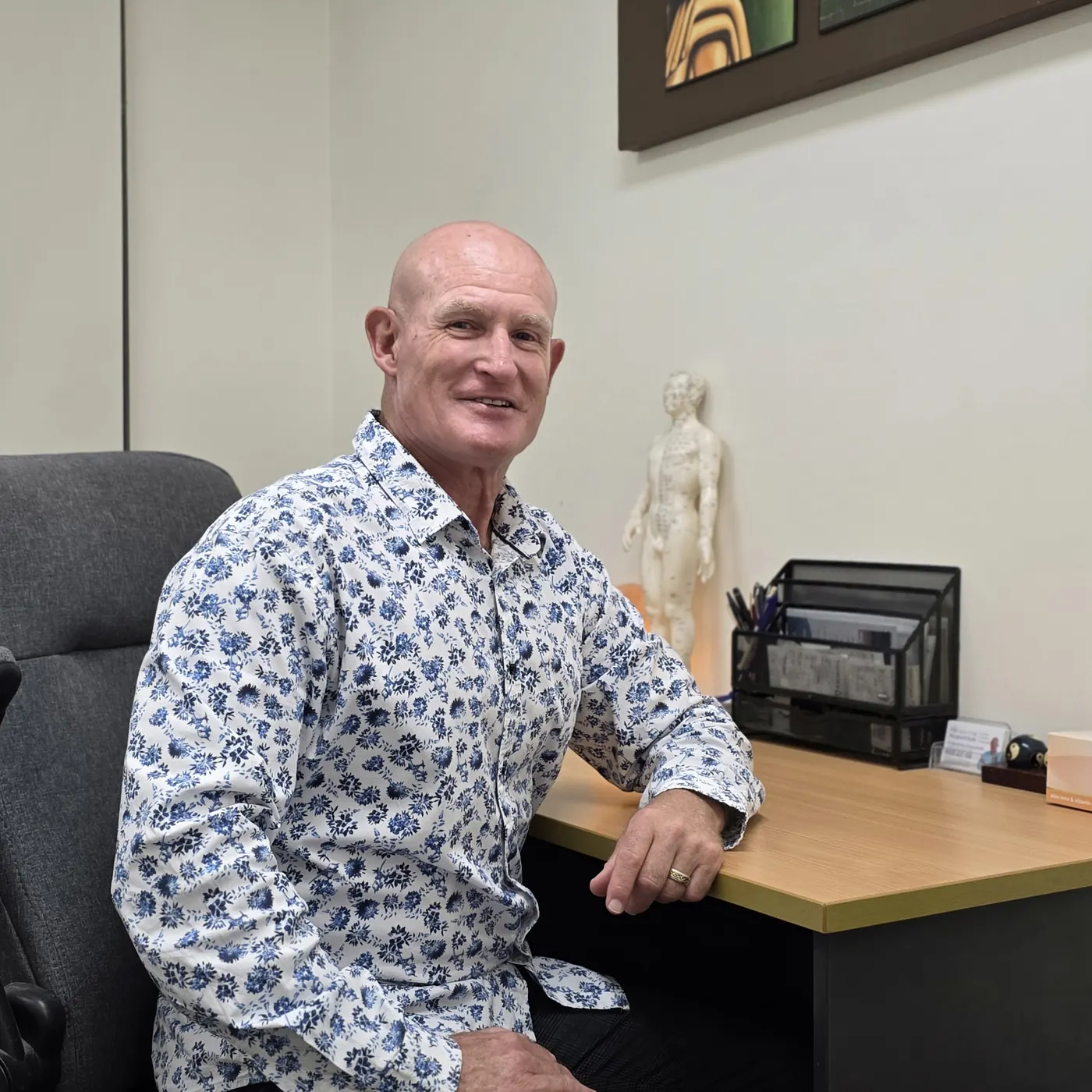 Dr Mal McKay at his desk in the clinic