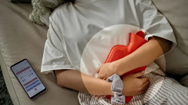 A woman resting with a hot water bottle