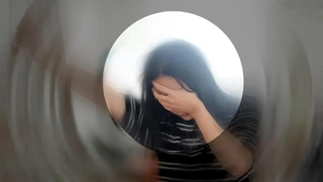 A tired person with head in hands